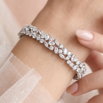 A close-up of a person's wrist wearing a diamond bracelet.