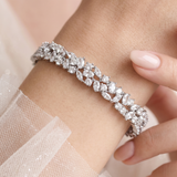 A close-up of a person's wrist wearing a diamond bracelet.