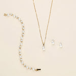 a necklace and earring set with pearls