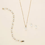 a necklace and earring set with pearls