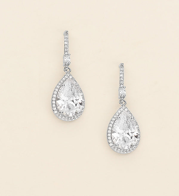 a pair of diamond earrings on a white background