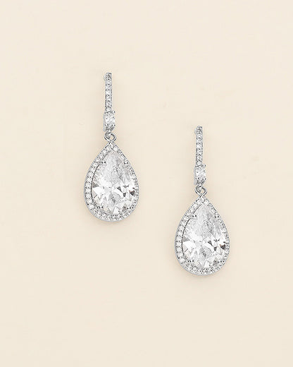 a pair of diamond earrings on a white background