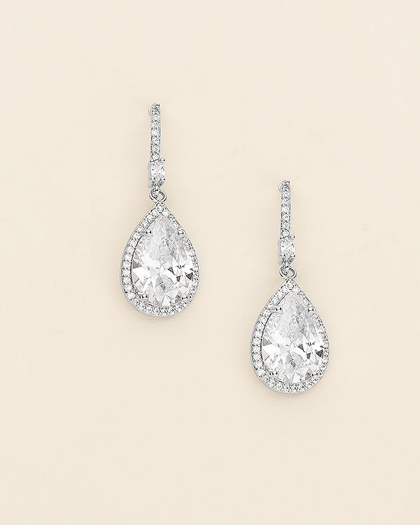 a pair of diamond earrings on a white background