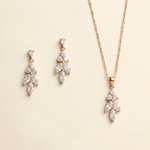 A necklace and earrings set made of gold and adorned with clear gemstones.
