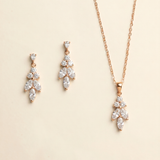 A necklace and earrings set made of gold and adorned with clear gemstones.