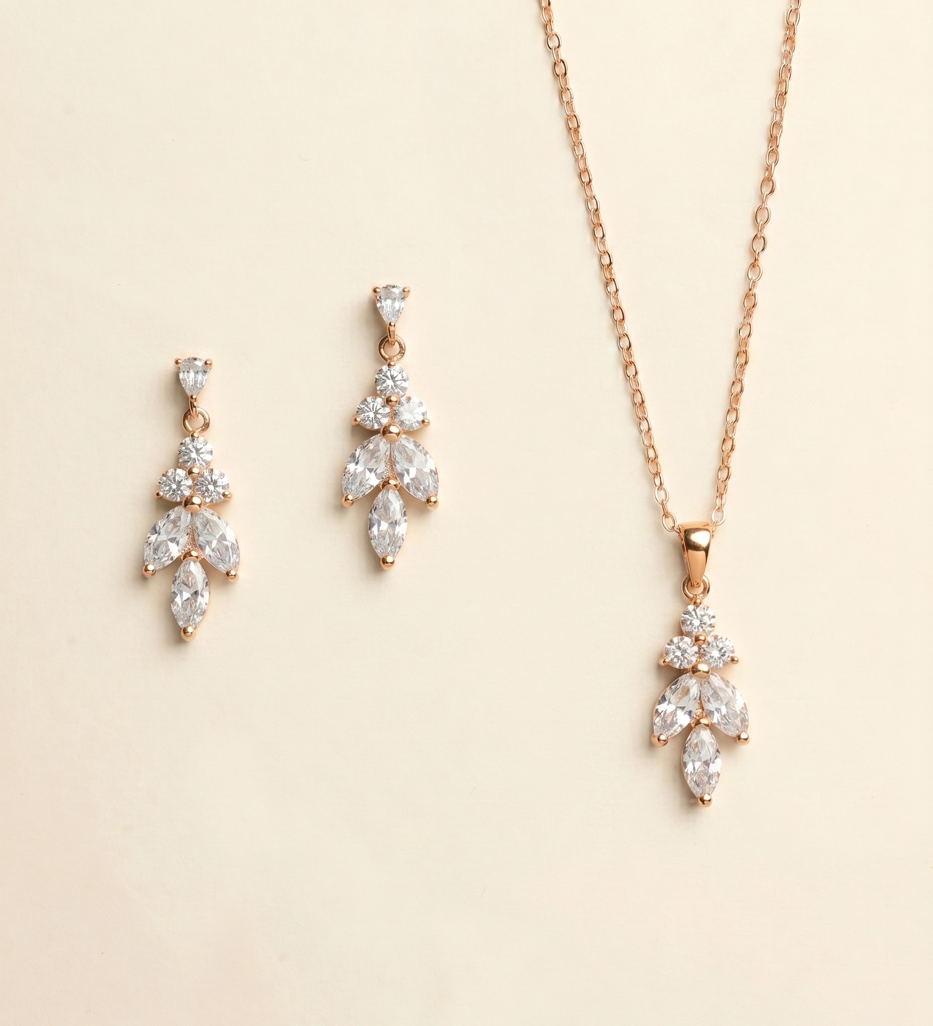 A necklace and earrings set made of gold and adorned with clear gemstones.