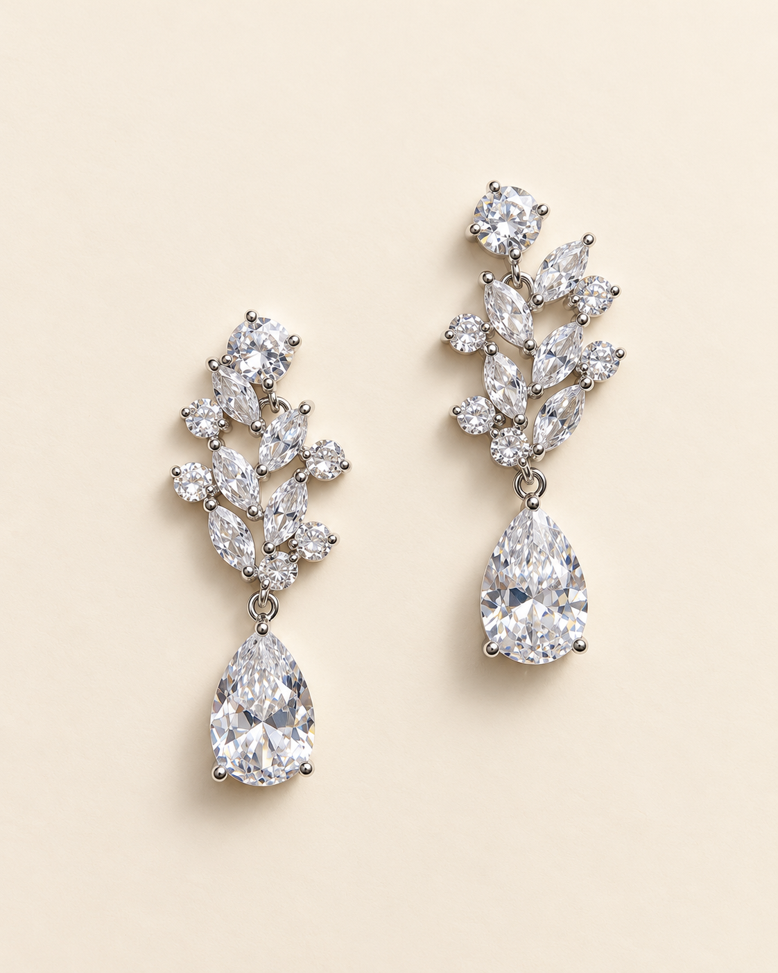 Pair of Josie silver-finish earrings showing clear round and marquise leaf accents with pear-shaped drops