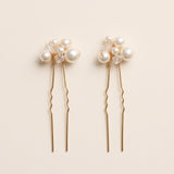 Two complete Mara pearl and crystal hair pins in gold.
