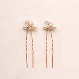 Two complete Mara pearl and crystal hair pins in rose gold.