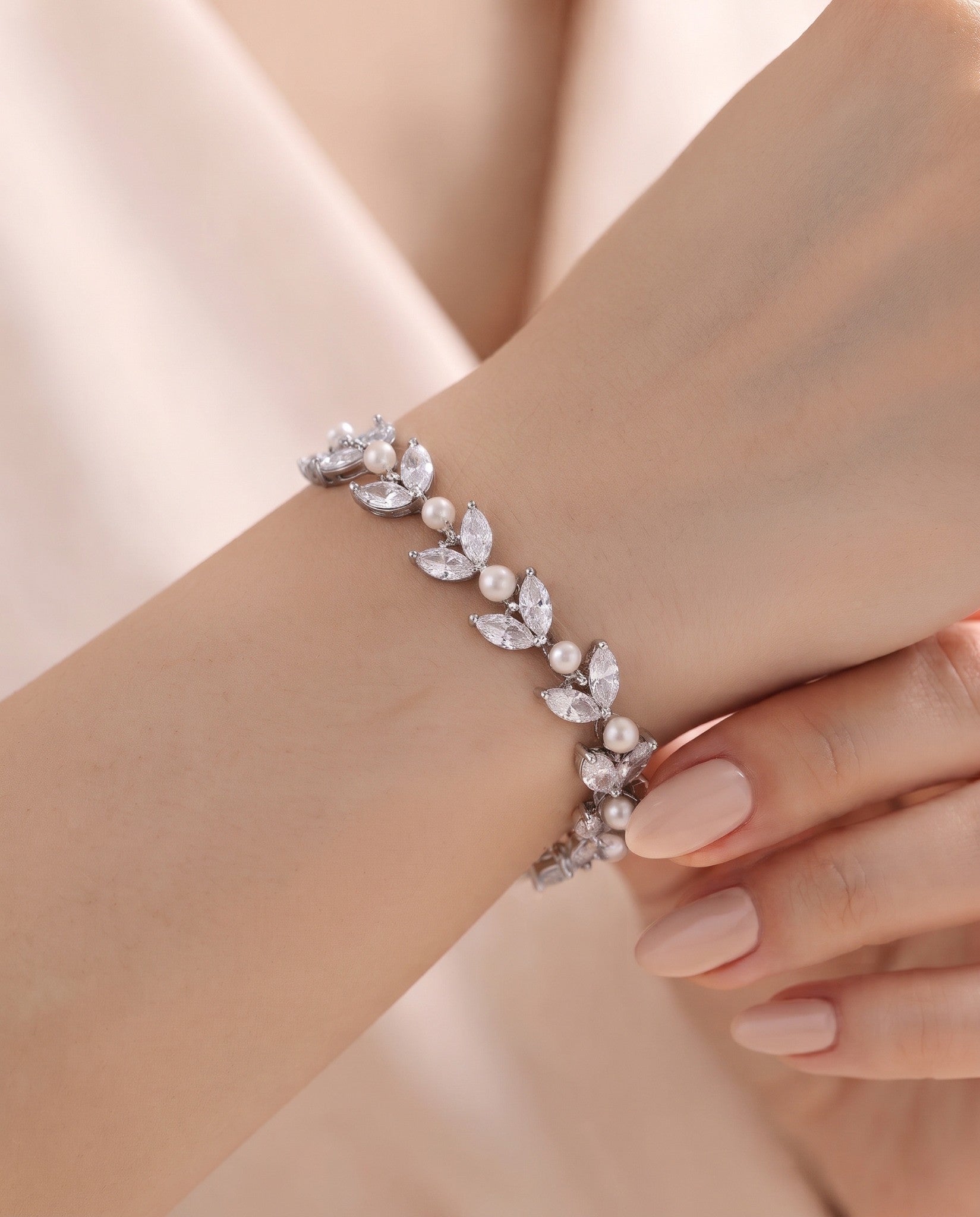Miranda silver-finish leaf bracelet worn on a wrist, showing clear marquise-shaped accents and round pearl-like details