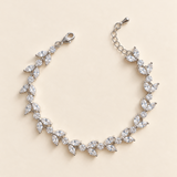 Vivienne silver-finish leaf-vine bridal bracelet with paired marquise-shaped and round clear accents on a cream background