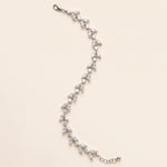 Full-length Vivienne silver-finish leaf bracelet on a cream background, showing the lobster clasp and extension chain