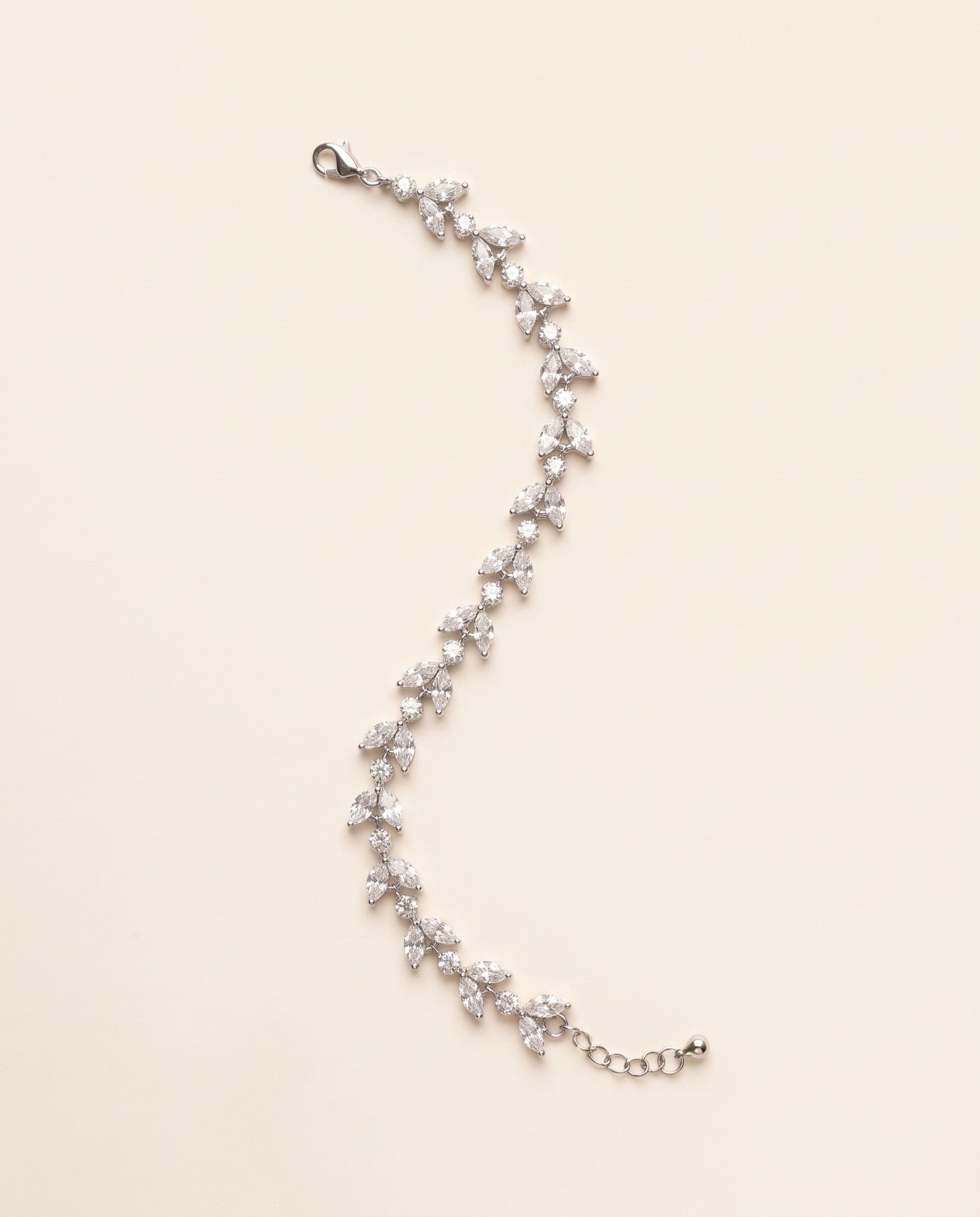 Full-length Vivienne silver-finish leaf bracelet on a cream background, showing the lobster clasp and extension chain
