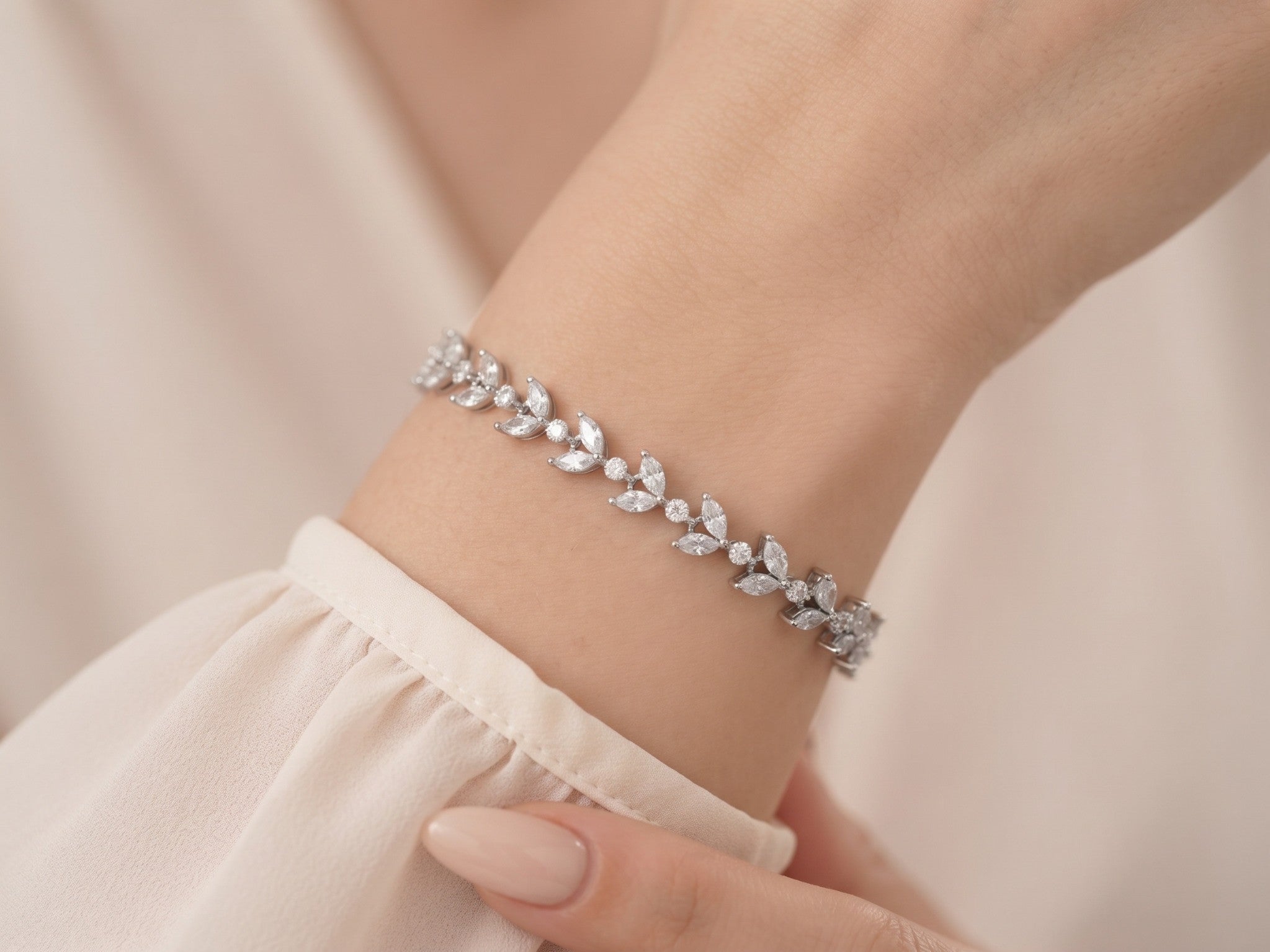 Vivienne silver-finish leaf bridal bracelet worn on a wrist with clear marquise-shaped and round accents