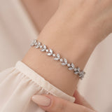 Vivienne silver-finish leaf bridal bracelet worn on a wrist with clear marquise-shaped and round accents