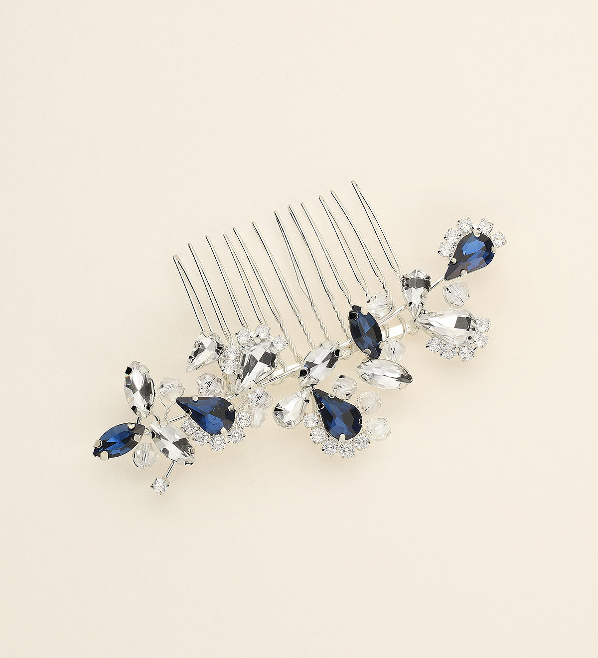a close up of a hair comb with blue and clear stones
