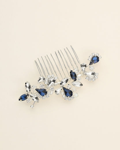 a close up of a hair comb with blue and clear stones