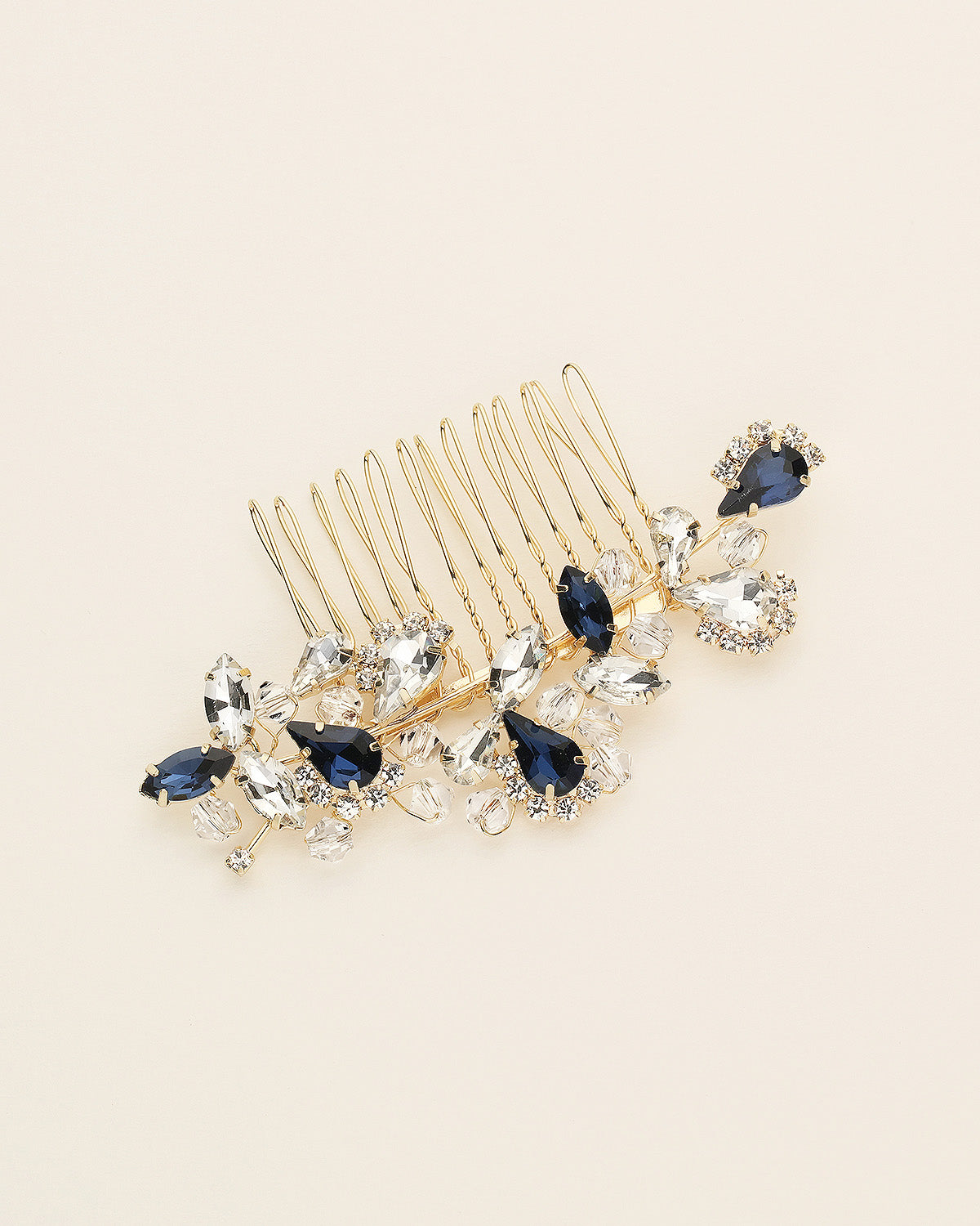 a hair comb with blue and clear stones on it