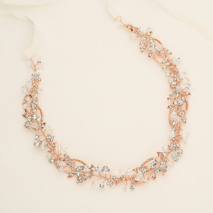 a close up of a necklace on a white surface